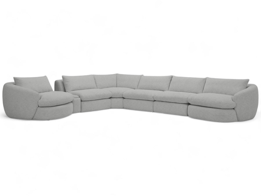 The Azelea Beige Sectional Sofa in a modern living room, featuring an elegant design with gently curved edges.