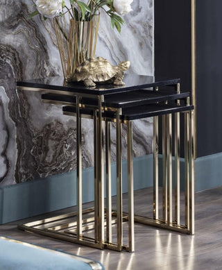 Sleek black glossy nesting table with striking golden metal legs, adding modern elegance to your space.