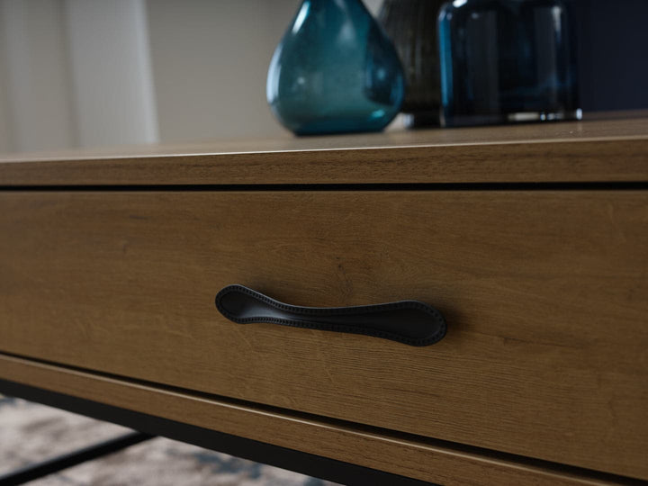 The Drift Coffee Table features a light-finished wood body that showcases natural grain variations.