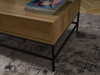 The Drift Coffee Table’s modern contrast of wood and metal adds visual interest to any room.