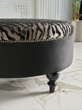 Comfortable Gaze Round Ottoman filled with premium-grade cushioning for relaxation.