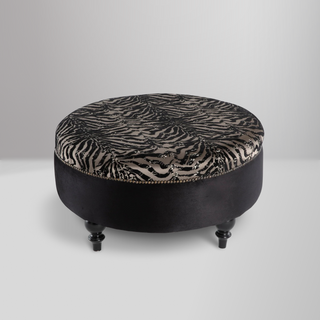 Gaze Round Ottoman with a sophisticated round design, premium cushioning, and subtle stitching details for versatile use