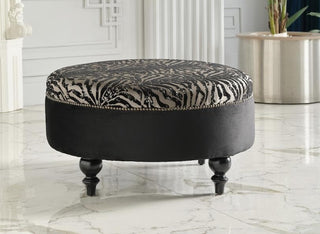 Sophisticated Gaze Round Ottoman with subtle stitching and a round silhouette.