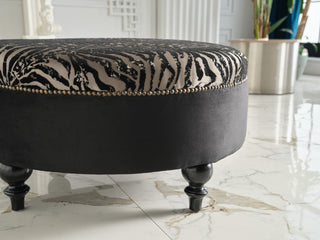 Versatile Gaze Round Ottoman, ideal as a seat, coffee table, or accent piece.