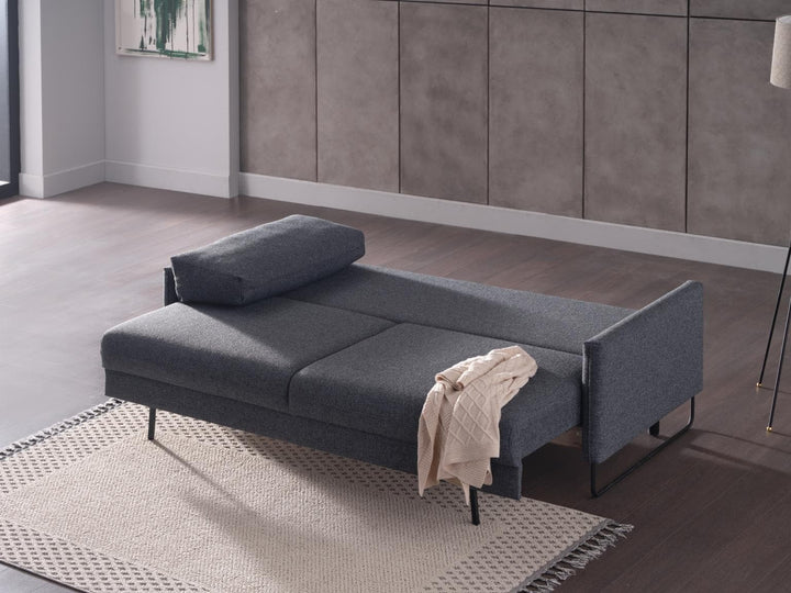 Modern Laura sofa with sleeper functionality and cozy velvet upholstery.