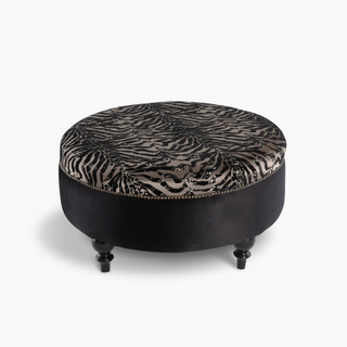 Luxury round ottoman in soft fabric, perfect as a footrest, extra seating, or stylish coffee table centerpiece