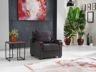 The Bennett Armchair with button-tufted seating and a blend of leatherette and fabric upholstery.