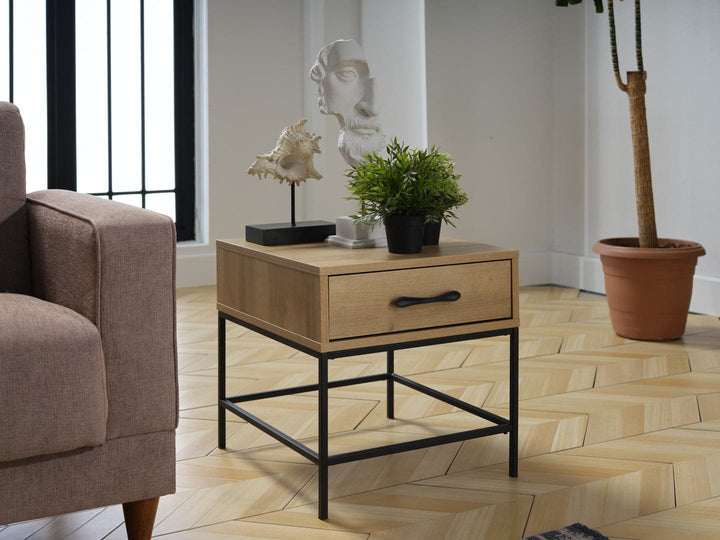 The light-finished wood body of the Drift Side Table complements its sleek black metal hardware.