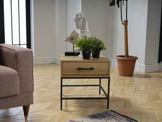 The Drift Side Table’s modern design and contrasting finishes add a stylish touch to any room.