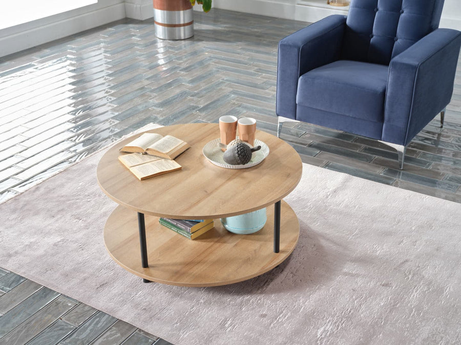 Round Elton Coffee Table with light-finished wood and exposed wrought iron legs.